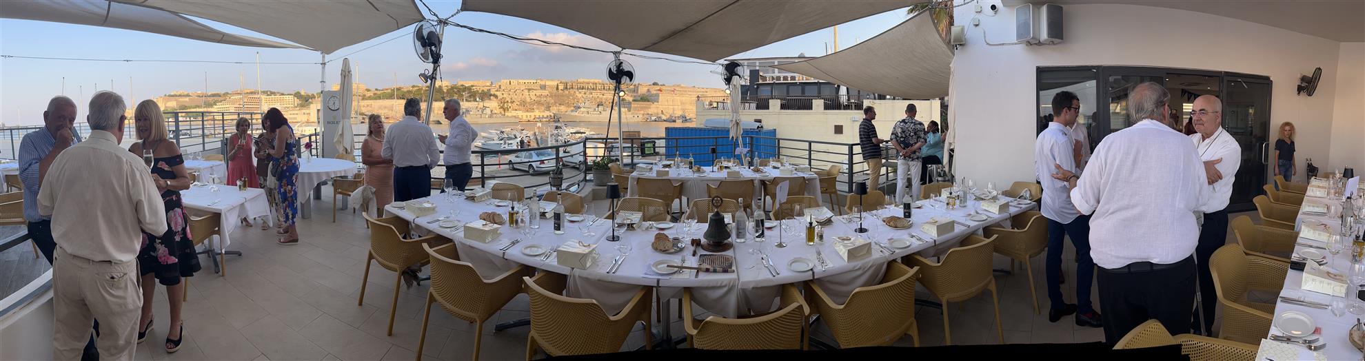Members and guests gathering by the harbour at the Royal Malta Yacht Club